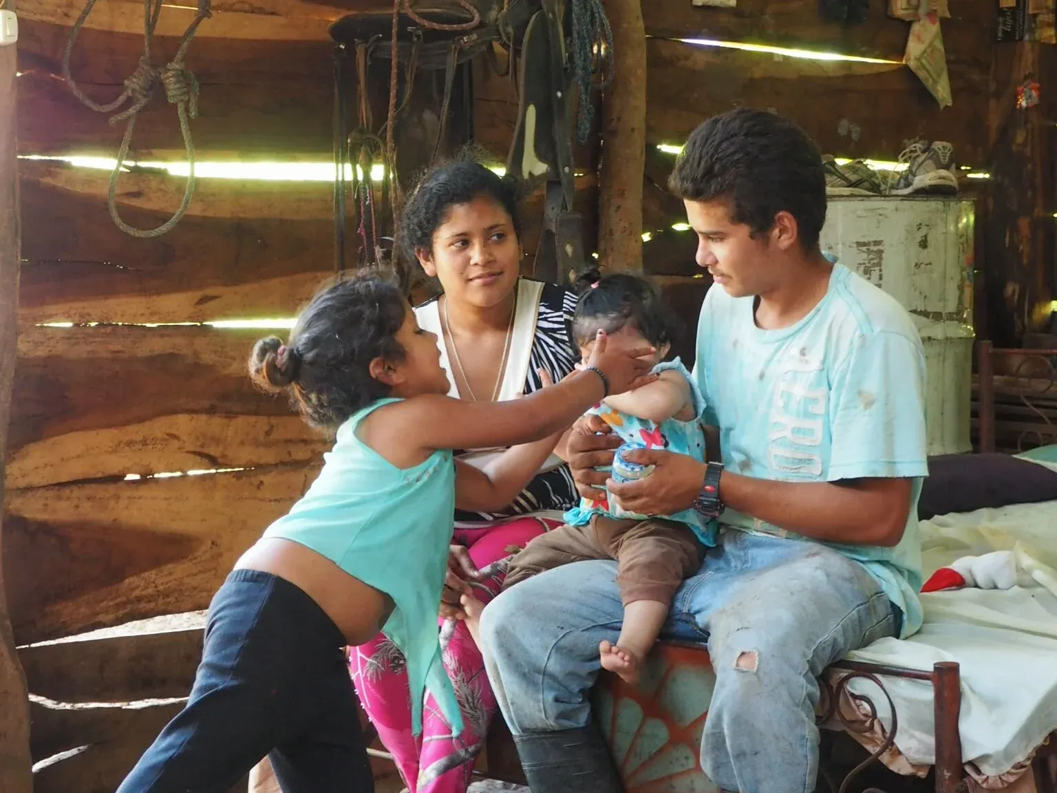 This is Alejandro (23) with his wife Maria (19), their infant daughter and Alejandro's niece. They live in a section of Isiquí called El Carizo, which is only reachable via a steep, 30min hike from the center of the village. They have no r…